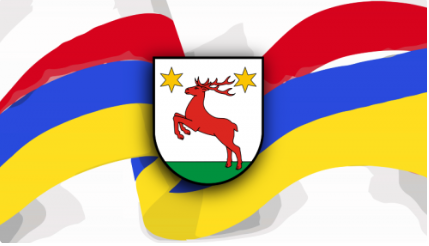 Barwy flagi Poliski i Ukrainy oraz logo gminy Łysomice